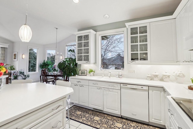 kitchen with white dishwasher, white cabinetry, and pendant lighting