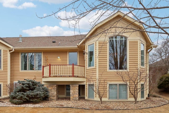 rear view of property featuring a balcony