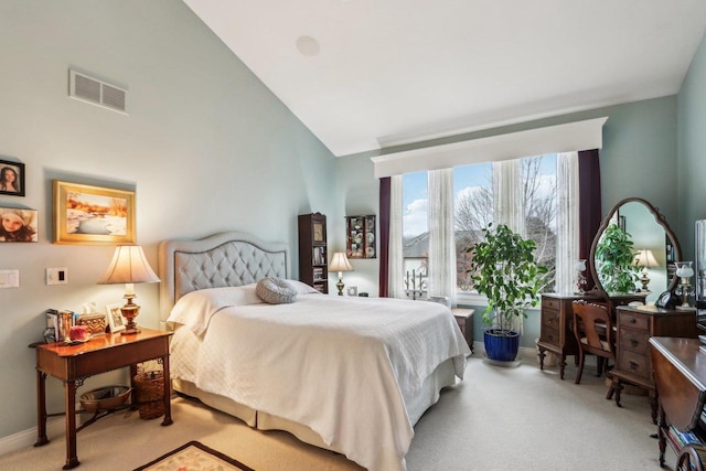 bedroom with light carpet and high vaulted ceiling