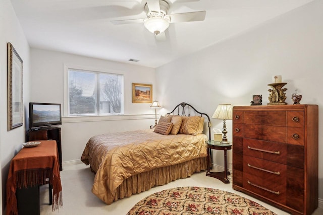 bedroom featuring light carpet and ceiling fan