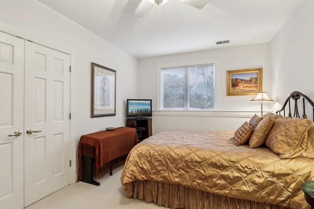 carpeted bedroom with ceiling fan and a closet