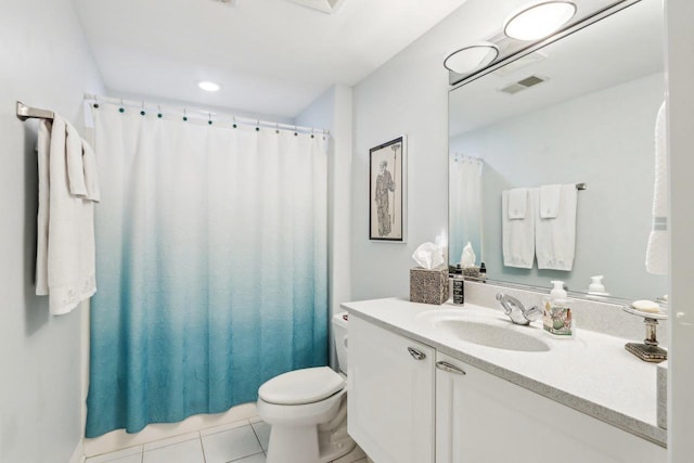 bathroom featuring vanity, toilet, and tile patterned flooring