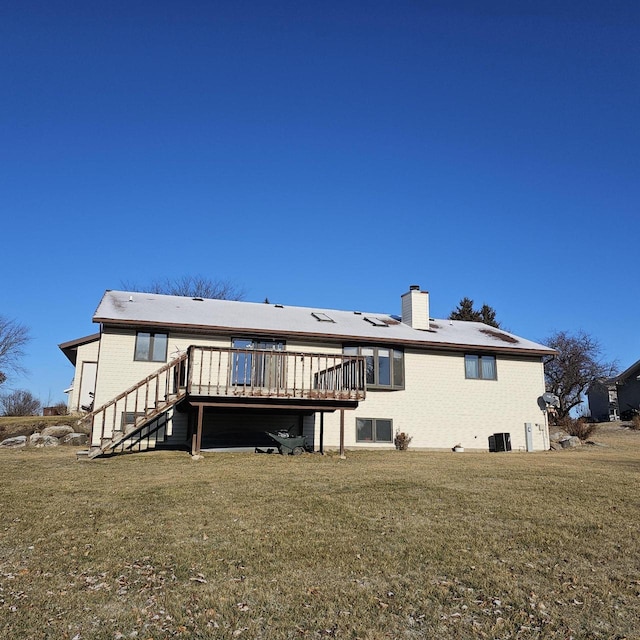 rear view of property with a wooden deck, a lawn, and central air condition unit