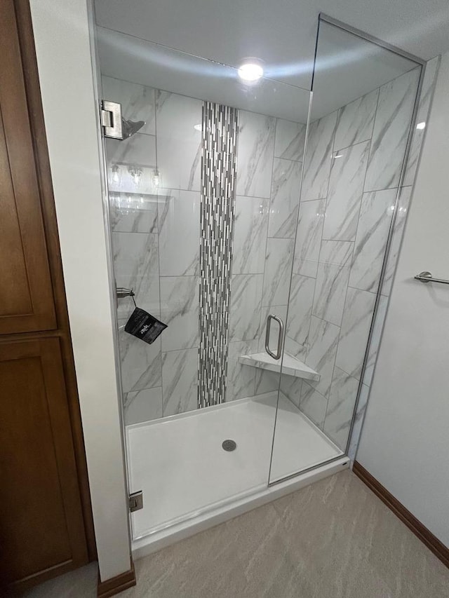 bathroom featuring a shower with door