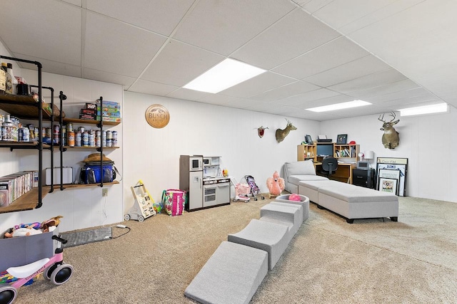 interior space featuring carpet floors and a paneled ceiling