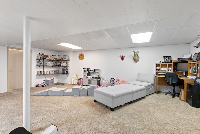 living room featuring carpet floors and a paneled ceiling