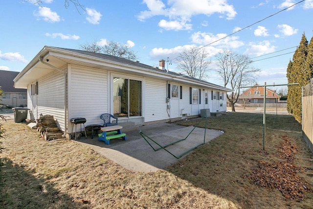 back of house with a yard, central AC, and a patio