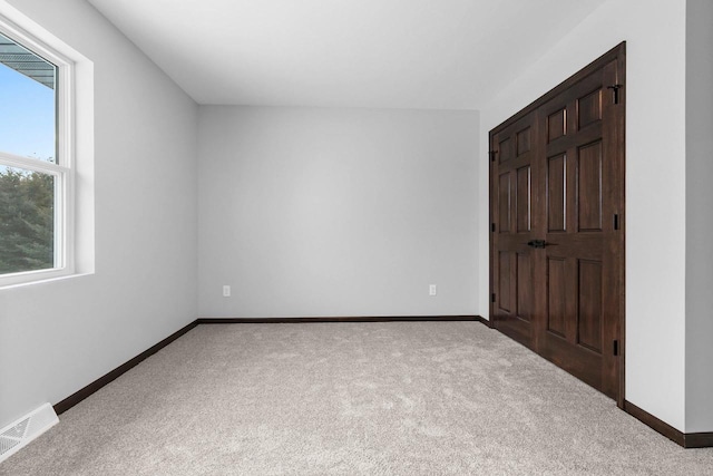 unfurnished bedroom featuring light colored carpet