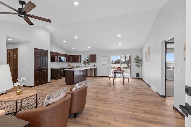 living room with high vaulted ceiling, light hardwood / wood-style floors, and ceiling fan