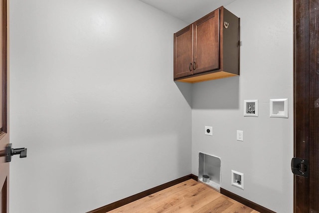 washroom featuring cabinets, electric dryer hookup, hardwood / wood-style flooring, and washer hookup