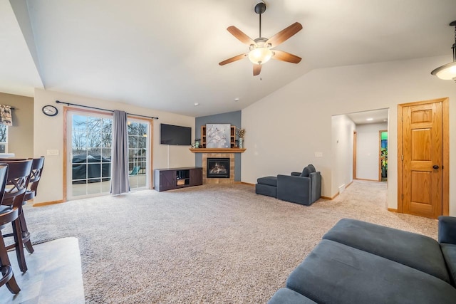 carpeted living room with ceiling fan, lofted ceiling, and a fireplace