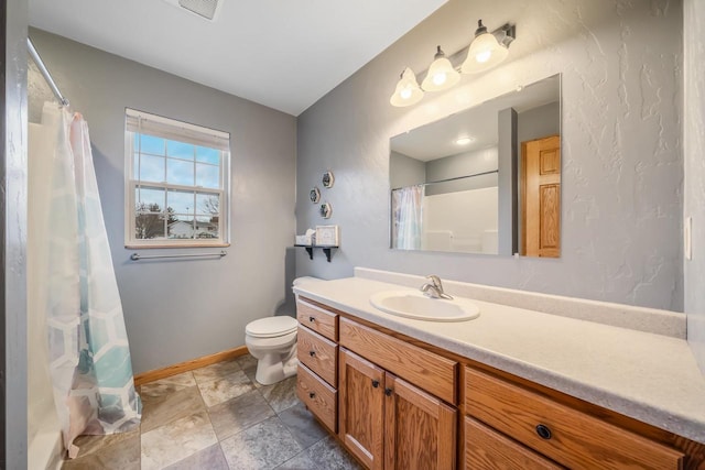 bathroom featuring vanity, curtained shower, and toilet