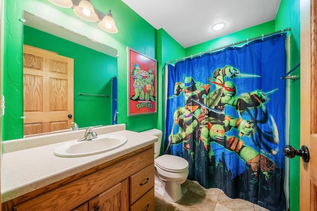 bathroom with vanity, tile patterned floors, and toilet