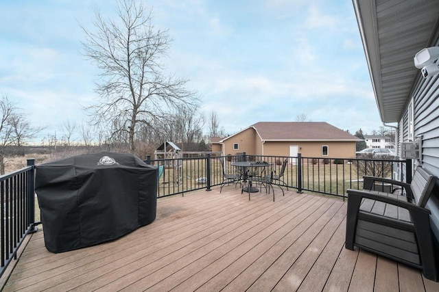 wooden terrace with a grill