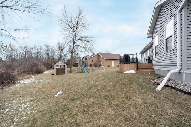 view of yard featuring a storage shed and a playground