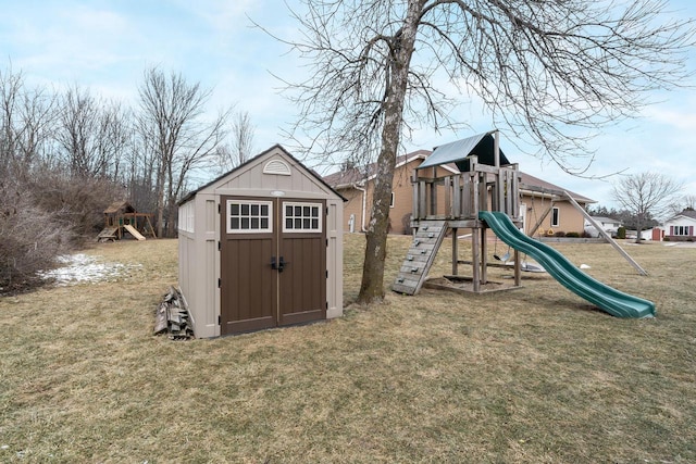 view of play area with a yard and a storage unit