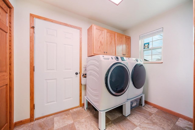 laundry room featuring cabinets and separate washer and dryer