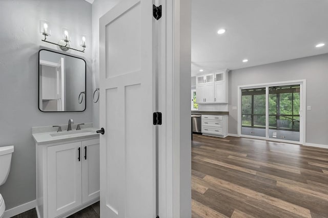 bathroom featuring hardwood / wood-style flooring, vanity, and toilet