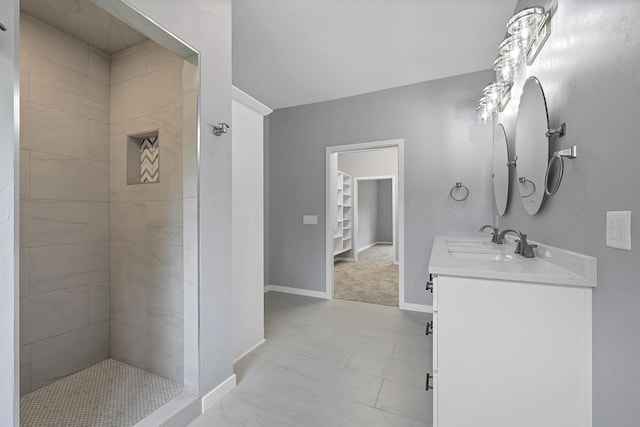 bathroom with vanity and tiled shower