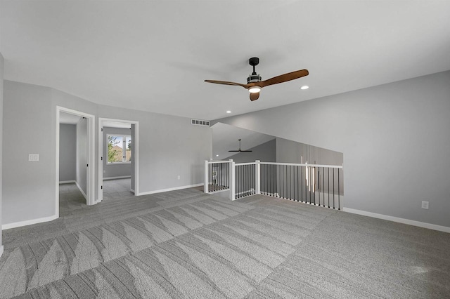 unfurnished living room featuring ceiling fan and carpet flooring