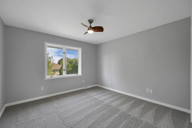 carpeted spare room with ceiling fan