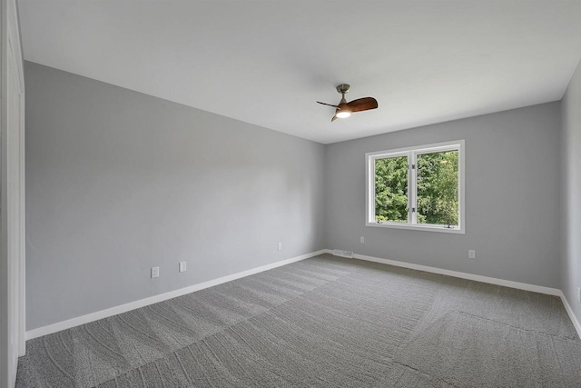 empty room featuring carpet floors and ceiling fan