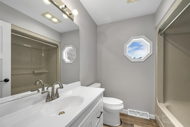 full bathroom with shower / bathtub combination, vanity, toilet, and hardwood / wood-style floors