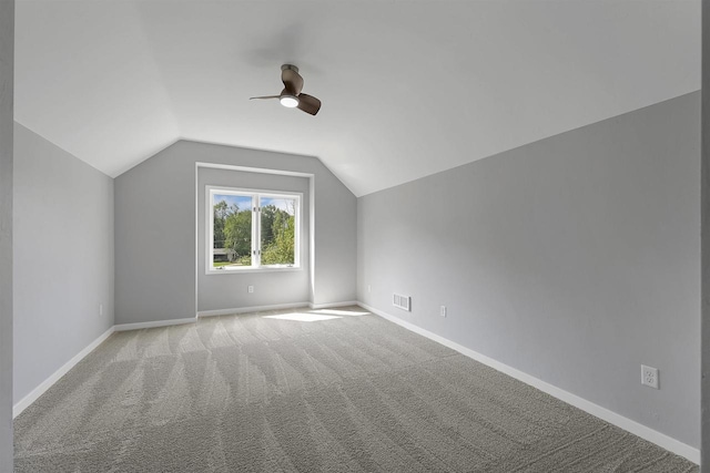 additional living space with lofted ceiling, light colored carpet, and ceiling fan