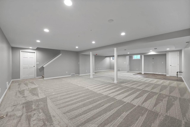 basement featuring light colored carpet