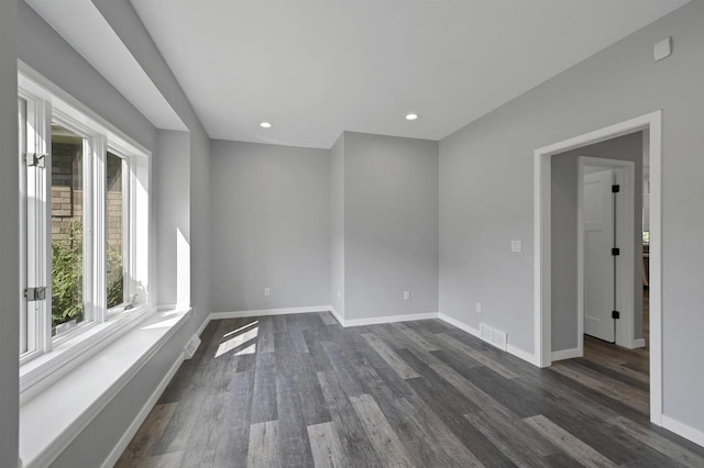 unfurnished room featuring dark wood-type flooring