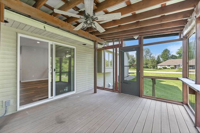 unfurnished sunroom with ceiling fan