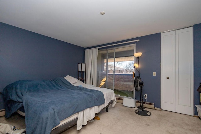 bedroom with light carpet and a baseboard radiator