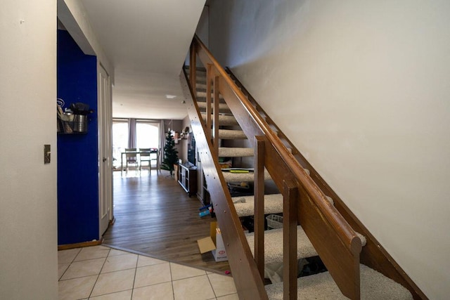 staircase featuring tile patterned floors