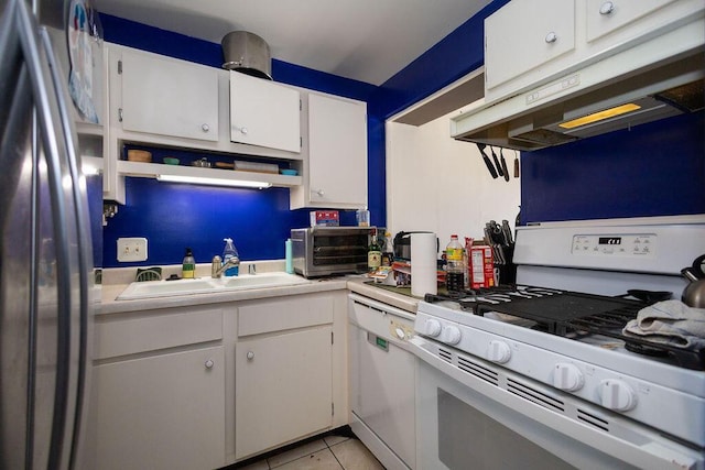 kitchen featuring white cabinetry, sink, light tile patterned floors, and white appliances