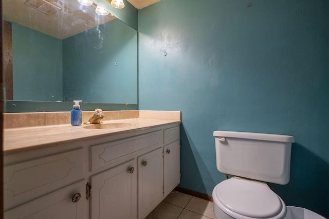 bathroom with tile patterned flooring, vanity, and toilet