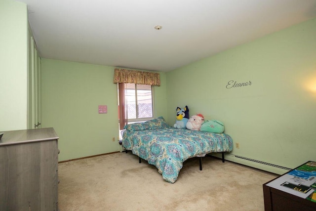 carpeted bedroom featuring a baseboard heating unit