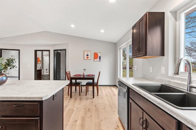 kitchen with sink, light hardwood / wood-style flooring, dishwasher, dark brown cabinetry, and vaulted ceiling