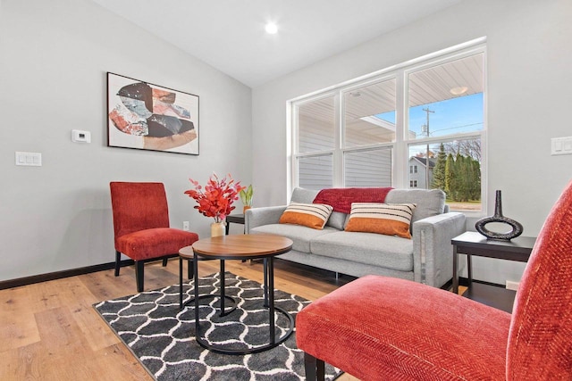 living area featuring hardwood / wood-style flooring and vaulted ceiling