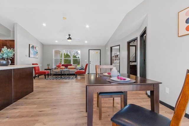 dining room featuring lofted ceiling, light hardwood / wood-style floors, and ceiling fan