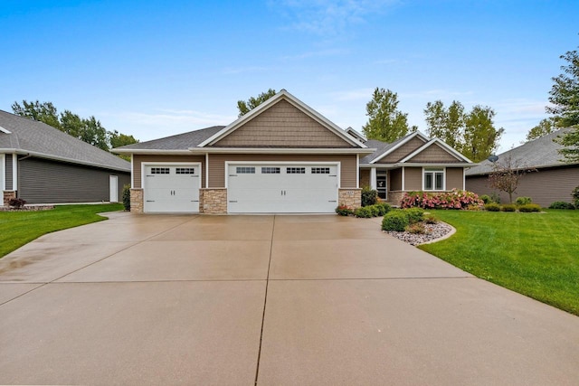 craftsman house with a garage and a front lawn