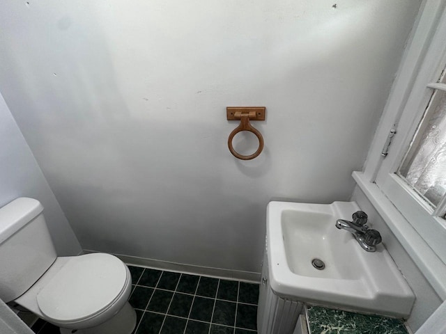 bathroom with tile patterned flooring, sink, and toilet