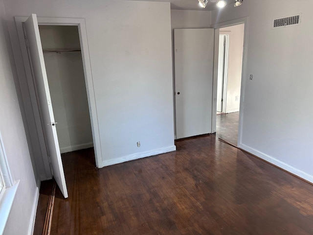 unfurnished bedroom featuring dark hardwood / wood-style floors