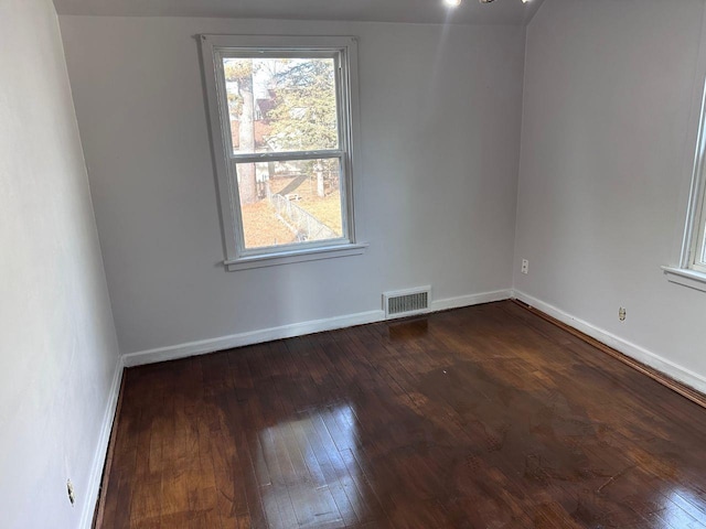 spare room with dark hardwood / wood-style floors