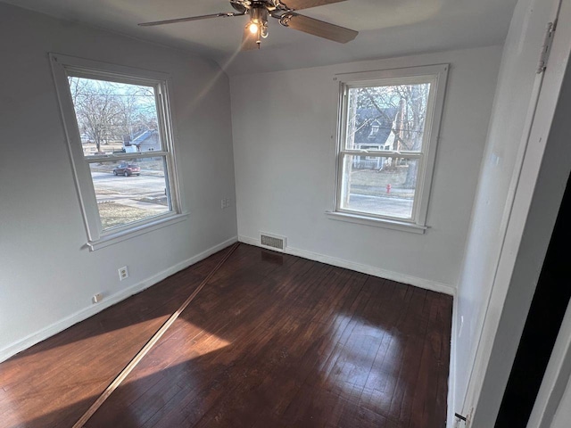 empty room featuring dark hardwood / wood-style floors and ceiling fan