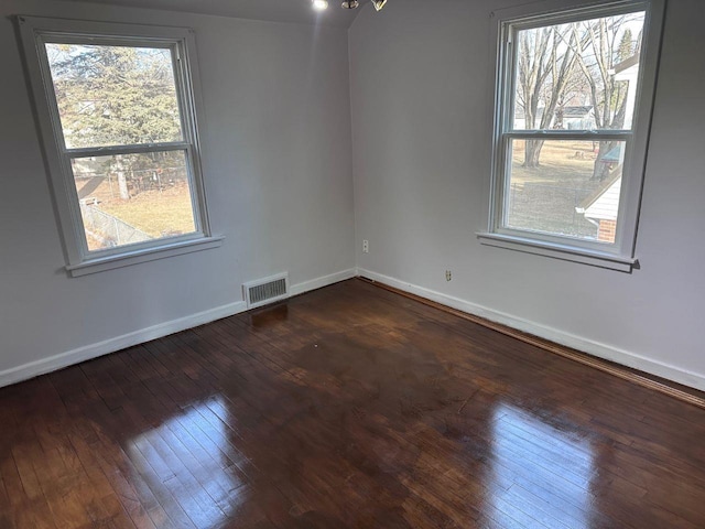 empty room with dark hardwood / wood-style floors