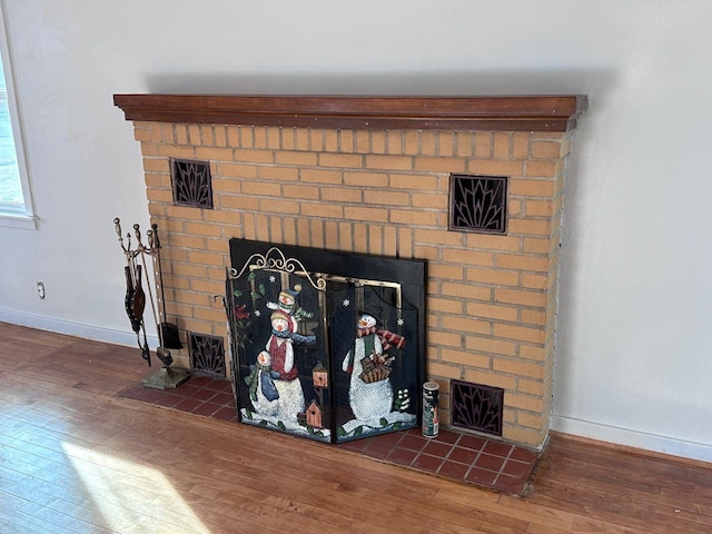 room details with hardwood / wood-style flooring and a brick fireplace