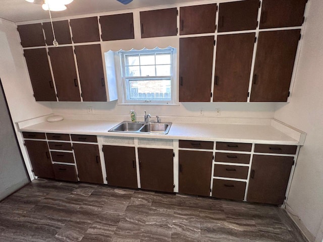 kitchen featuring dark brown cabinetry and sink