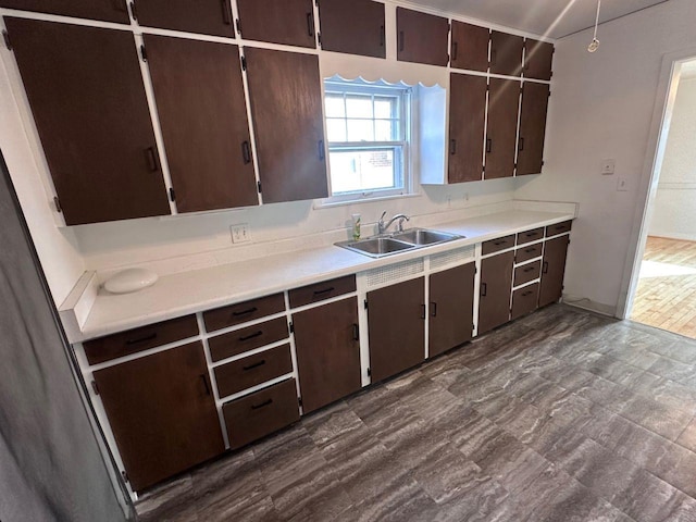 kitchen featuring dark brown cabinetry and sink