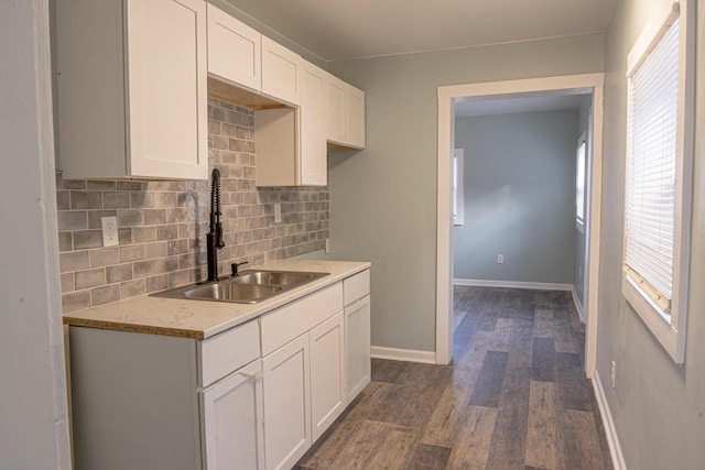 kitchen featuring white cabinetry, dark hardwood / wood-style floors, sink, and decorative backsplash