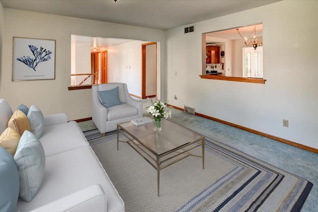 living room with carpet floors and a notable chandelier